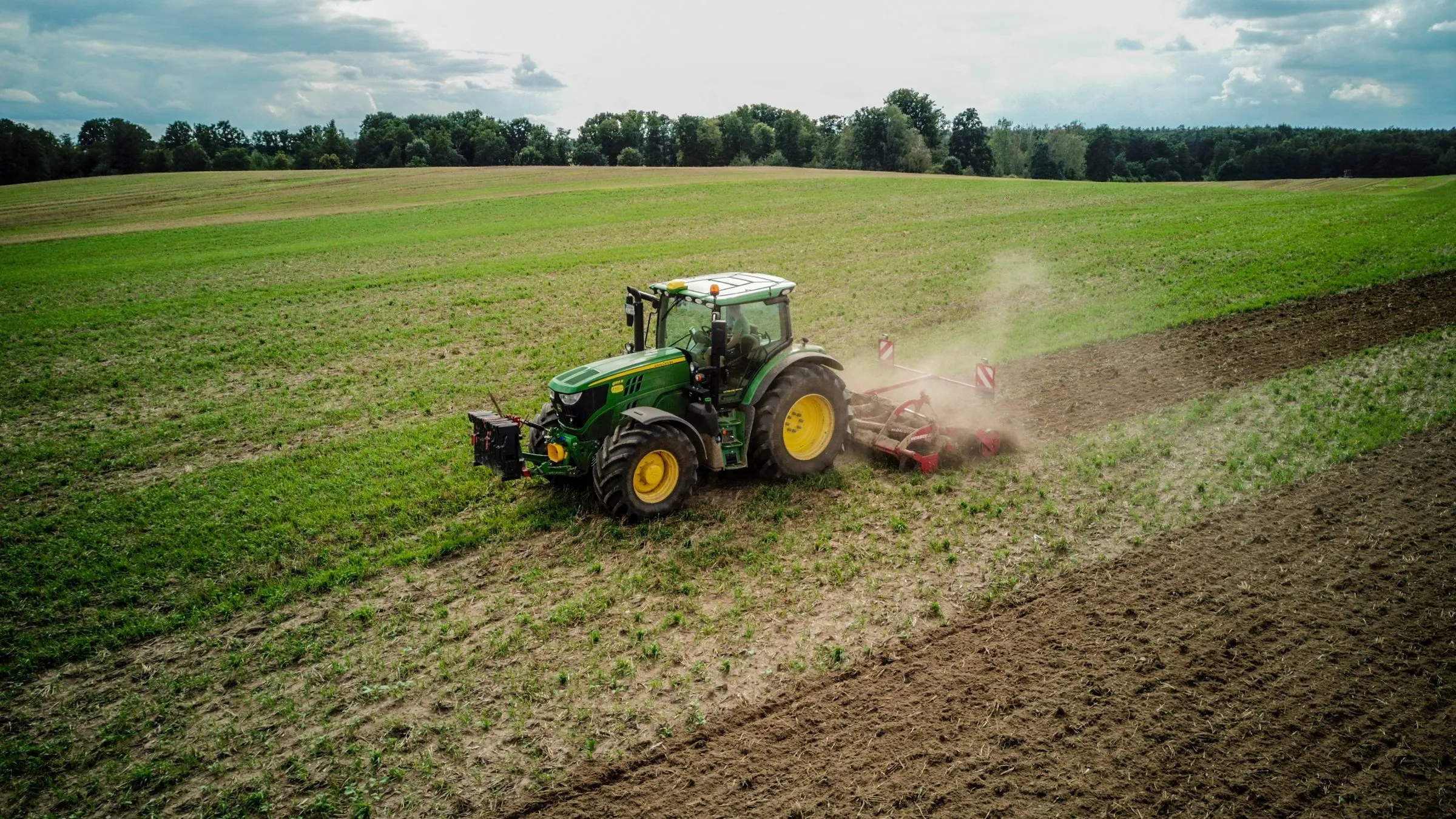 Tractor con rastra preparando la tierra en una ladera